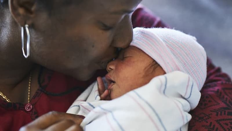 Black woman holding a baby
